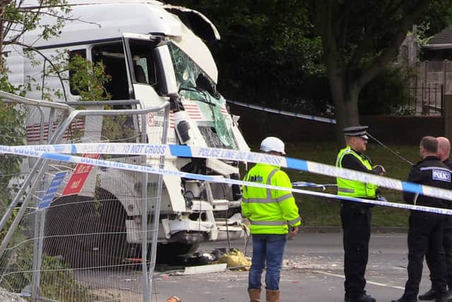 A woman died after being hit by a lorry before it crashed into a house in Barnsley which has been left severely damaged