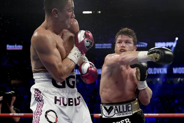 Gennady Golovkin, left, and Canelo Alvarez trade punches in the fifth round during a middleweight title boxing match, Saturday, Sept. 15, 2018, in Las Vegas. (AP Photo/Isaac Brekken