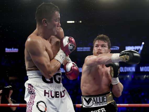Gennady Golovkin, left, and Canelo Alvarez trade punches in the fifth round during a middleweight title boxing match, Saturday, Sept. 15, 2018, in Las Vegas. (AP Photo/Isaac Brekken