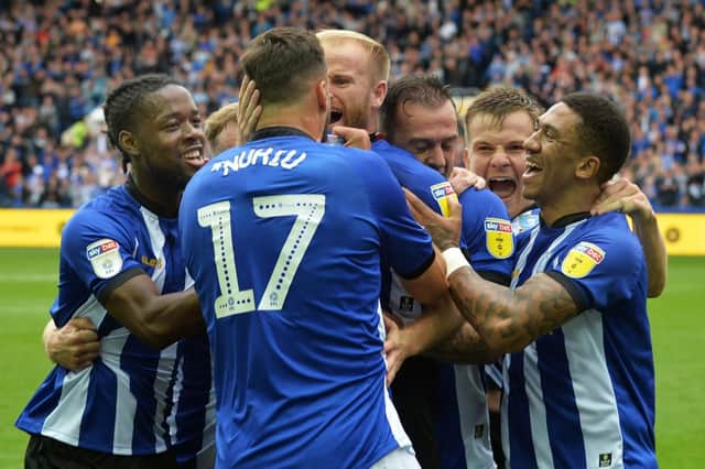 Barry Bannan is mobbed by Sheffield Wednesday team mates after his equaliser