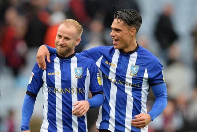 Pelupessy, right, celebrating with Sheffield Wednesday teammate Barry Bannan after the team's win against Villa