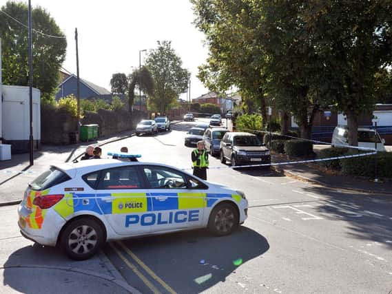 Police at the scene of the double stabbing on Walkley Lane, in Hillsborough
