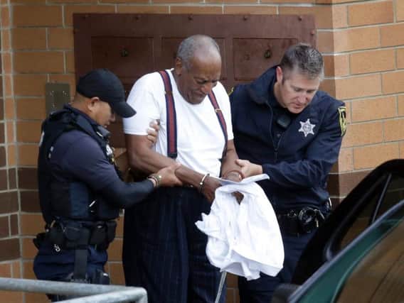 Bill Cosby is escorted out of the Montgomery County Correctional Facility Tuesday Sept. 25, 2018 in Eagleville, Pa., following his sentencing to three-to-10-year prison sentence for sexual assault. AP Photo/Jacqueline Larma