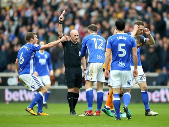 Birmingham City's Harlee Dean (No12) is shown a red card by referee Andy Davies