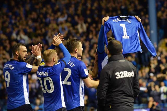 Adam Reach holds up a shirt dedicated to Hayley Kalinins, the wide of Sheffield Wednesday fitness coach Andy, who died last week......Pic Steve Ellis