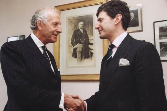 Michael Frampton hands over to his son Jimmy at H L Brown under the watchful eye of their forefather, Harris Leon Brown, in November 2001