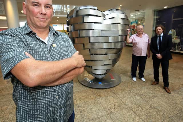 The unveiling of the Heart of Steel at Meadowhall. Pictured is artist Steve Mehdi, former steel worker Terry Mansell and Meadowhall Centre Marketing Director Richard Pinfold. Picture: Chris Etchells