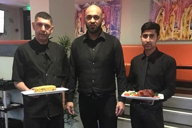 Harood Harry Tariq, head waiter at Seven Spices Balti, Sheffield, is pictured middle with other members of staff. Photo by Molly Williams.