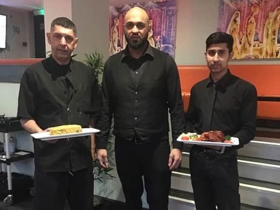 Harood Harry Tariq, head waiter at Seven Spices Balti, Sheffield, is pictured middle with other members of staff. Photo by Molly Williams.
