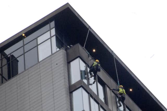 Structural engineers assess the loose cladding. Picture: Sam Cooper / The Star.