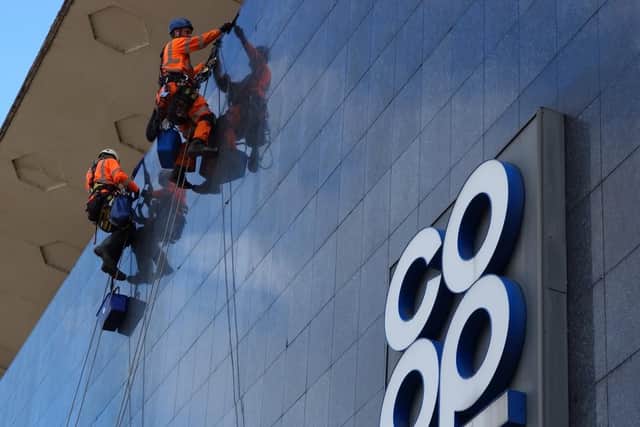 Cleaners abseil down the buidling