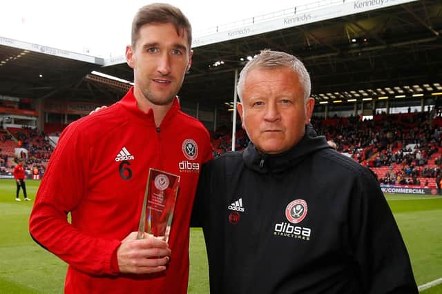 Chris Basham is presented with a memento of his 200th Blades start by Blades boss Chris Wilder (Simon Bellis/Sportimage)