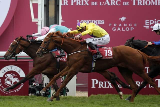 Enable, ridden by Frankie Dettori, just holds off fellow British filly Sea Of Class to win her second successive Qatar Ptix de l'Arc de Triomphe at Longchamp on Sunday.
