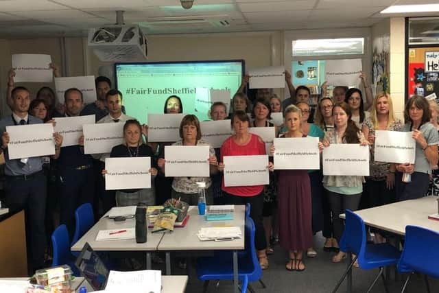Staff at Ballifield Primary School show their support for the funding campaign