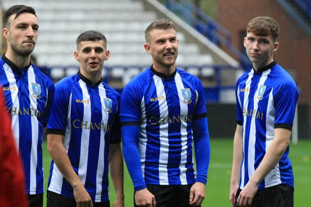 Sam Winnall (second right) cracks a smile on his return to action for the Owls