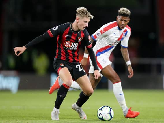 Bournemouth's David Brooks (left) and Crystal Palace's Patrick van Aanholt battle for the ball during the Premier League match