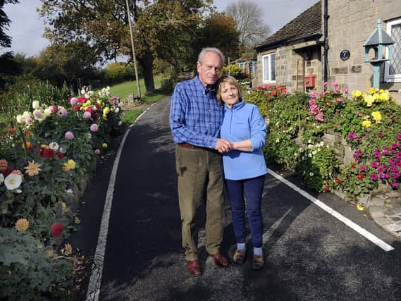 Pictured are Sally and Brian Williams outside their cottege on Hollin House Lane, Loxley Valley,who are in dispute with Sheffield City Council over their flower beds