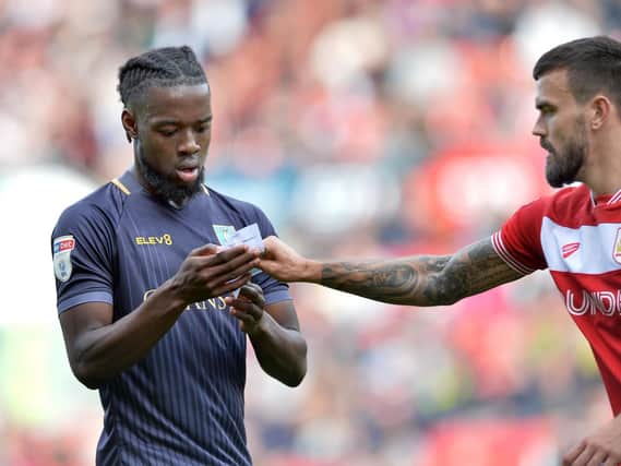 Josh Onomah reading a tactical note in Sheffield Wednesday's clash at Bristol City