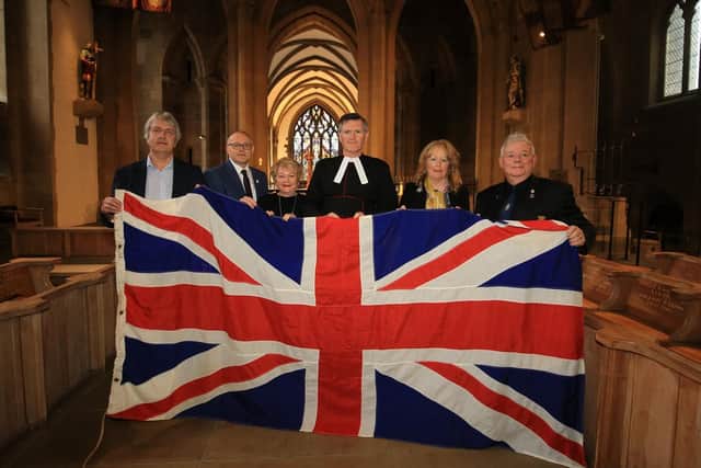 Installing a flag from HMS Sheffield at the Cathedral. Pictured are Kevan Shaw who donated the outstanding moeny needed to install the flag and Tanzy Lee from the HMS Sheffield Association.