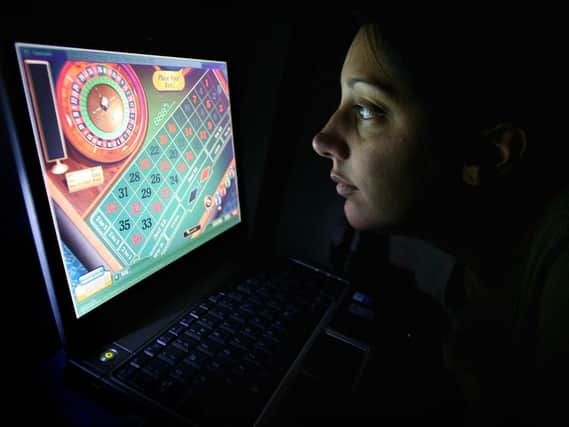 A woman uses an internet gambling website to play online roulette: Gareth Fuller/PA
