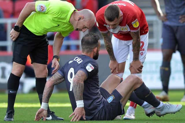 Owls Steven Fletcher has to leave the field injured as he is consoled by Citys ex Wednesday player Jack Hunt......Pic Steve Ellis