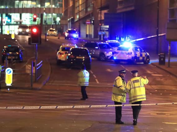 Emergency services at the scene on the night of the attack. Picture: Peter Byrne/PA Wire.