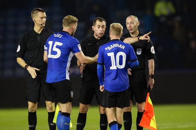 A furious Tom Lees and Barry Bannan with referee Peter Bankes at the final whistle after Sheffield Wednesday's defeat to Middlesbrough