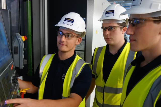 Apprentice machinists at Boeing Sheffield, Rhys Lister, Thomas Pledger and Joshua Thomson. with a five axis horizontal CNC milling machine