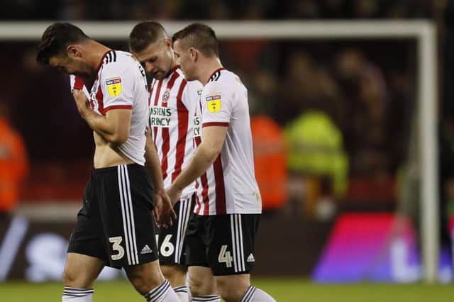 A frustrated Enda Stevens walks off with John Fleck and Oliver Norwood after the Stoke draw
