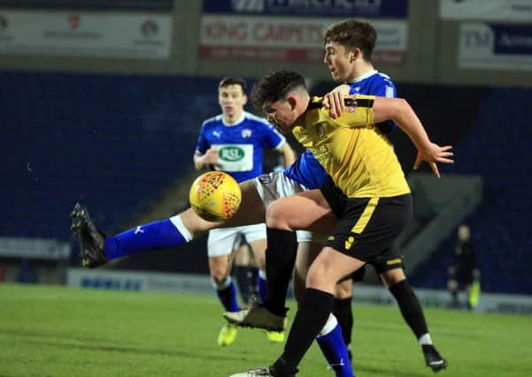 Chesterfield v Belper Town in the Derbyshire Senior Challenge Cup quarter final, Tuesday January 9th 2018.  Chesterfield player Jamie Sharman and Belper player Sam Birks in action. Picture: Chris Etchells