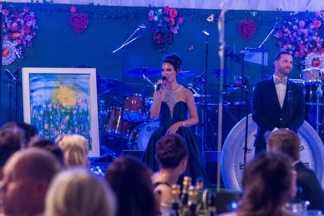 Sarah and Paul Mullen with auction prize - painting from Daisy Watt, aged 8 from Misson. Painting is called 'A New Day' and was inspired by Daisy's grandma who survived cancer.  The painting sold at auction for 5200 (Picture: Andrew Kelly photography)