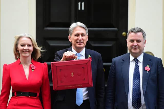 Chancellor Philip Hammond holds his red ministerial box outside 11 Downing Street, London, flanked by Treasury colleagues Liz Truss (left) and Mel Stride, before heading to the House of Commons to deliver his Budget. Picture: David Mirzoeff/PA Wire