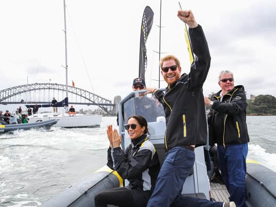 The Duke and Duchess of Sussex cheer on competitors taking part in a sailing event at the 2018 Invictus Games in Sydney harbour. Picture: Chris Jackson/Invictus Games Foundation/PA Wire