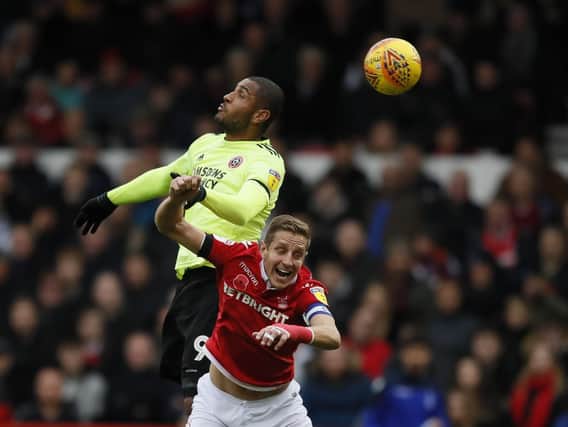 Leon Clarke beats Michael Dawson to the ball in Sheffield United's clash with Nottingham Forest