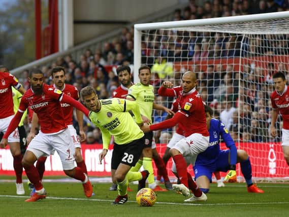 Martin Cranie battles with Nottingham Forest's defence: Simon Bellis/Sportimage