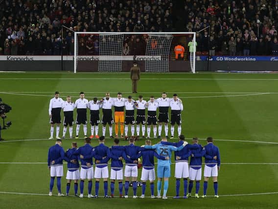 Players from both Sheffield United and Sheffield Wednesday line up for a minutes silence during the Sky Bet Championship match at Bramall Lane Stadium, Sheffield