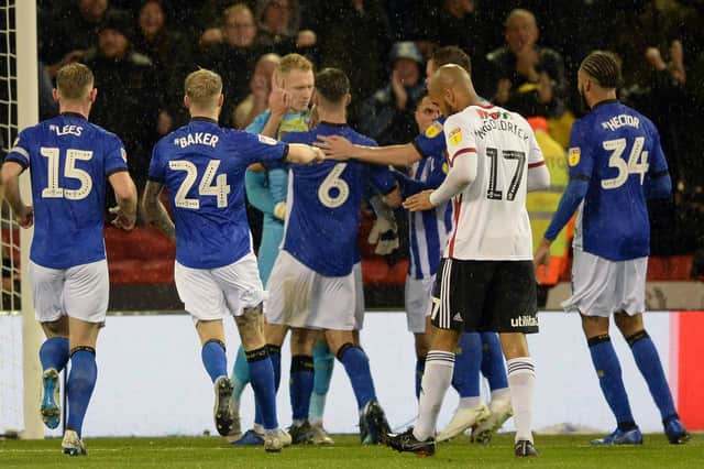 Owls Cameron Dawson after his penalty save mobbed by team-mates.....Pic Steve Ellis