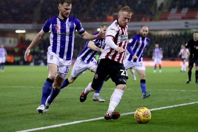Sheffield United's Mark Duffy (right) and Sheffield Wednesday's Tom Lees (left) battle for the ball during the Sky Bet Championship match at Bramall Lane.