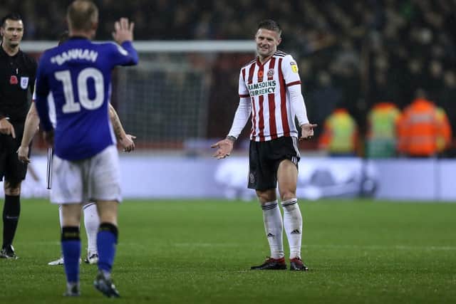 Oliver Norwood of Sheffield United gestures to Barry Bannan of Sheffield Wednesday after he threw the ball away to waste time: James Wilson/Sportimage