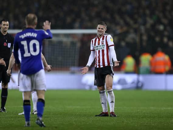 Oliver Norwood of Sheffield United gestures to Barry Bannan of Sheffield Wednesday after he threw the ball away to waste time: James Wilson/Sportimage