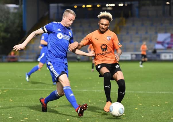 ChesterfieldÃ¢Â¬"s Andrew Kiwomya competes for the ball with FC Halifax Town's Nathan Clarke: Picture by Steve Flynn/AHPIX.com, Football: Vanarama National League match FC Halifax Town -V- Chesterfield at The Shay, Halifax, West Yorkshire, England on copyright picture Howard Roe 07973 739229