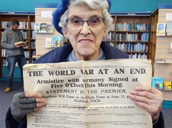 Barbara Hall with her newspaper recording Armistice in 1918