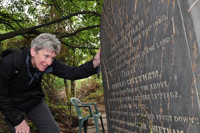 Alison Davies looks at a gravestone during an open day at the Zion Graveyard.