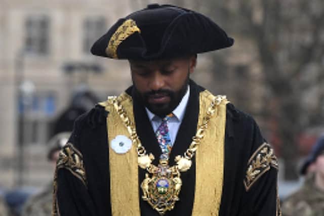 Lord Mayor of Sheffield Coun Magid Magid, wearing a white poppy, at the remembrance parade at Barkers Pool.