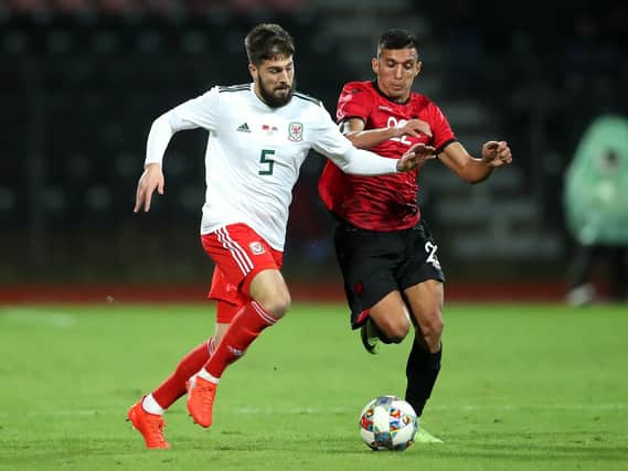 Wales' Kieron Freeman (left) and Albania's Myrto Uzuni (right) battle for the ball during the international friendly match at the Elbasan Arena. : Adam Davy/PA Wire. RESTRICTIONS: Editorial use only. No commercial use.