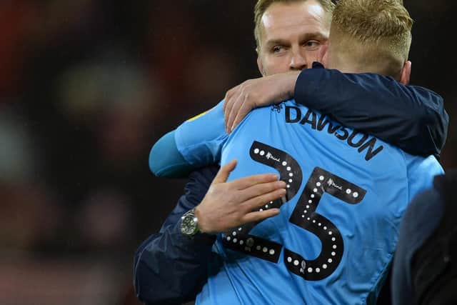 Owls hero keeper Cameron Dawsongets a hug from his Coach Nicky Weaver.......Pic Steve Ellis