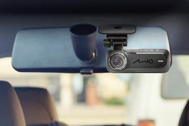 The Mio MiVue J60 Dash Cam fits discreetly behind the rear view mirror