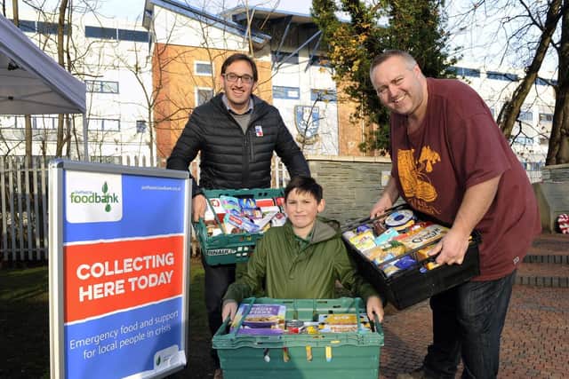 Pictured are Coun Ben Curran with his son James and Chris Hardy, from the S6 Foodbank