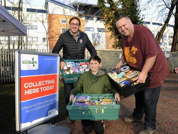 Pictured are Coun Ben Curran with his son James and Chris Hardy, from the S6 Foodbank