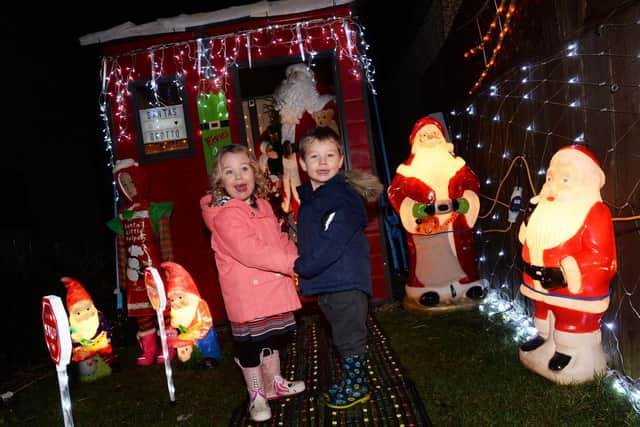 The Christmas Lights display at 52 Westfield Ave, Thurlstone, the home of David Horne. The Christmas wonderland is to raise money for West Yorkshire Dog Rescue. Pictured are three-year-old twins Jacob and Ella Saunders. Picture: Steve Ellis.